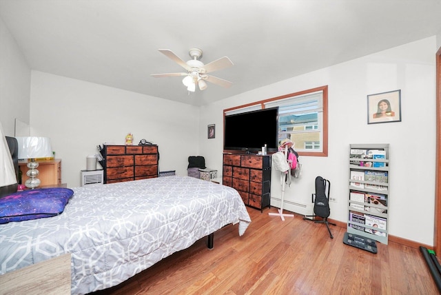 6568 W Roscoe St Unit 2N, Chicago, IL 60634 - bedroom with wood finished floors, a baseboard radiator, baseboards, and ceiling fan