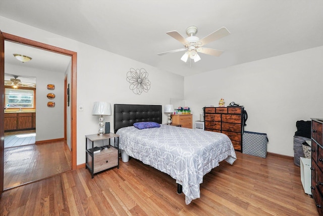 6568 W Roscoe St Unit 2N, Chicago, IL 60634 - bedroom with wood finished floors, baseboards, and a ceiling fan