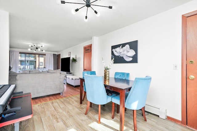 6568 W Roscoe St Unit 2N, Chicago, IL 60634 - dining area featuring a chandelier, a baseboard radiator, and light wood-type flooring