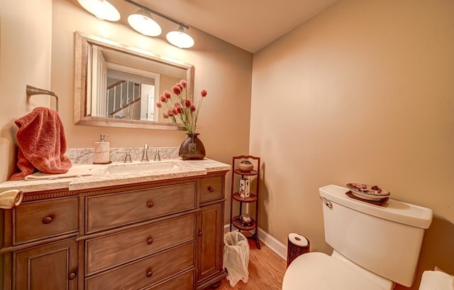 713 Warwick Ln, Lake Zurich, IL 60047 - bathroom featuring toilet, vanity, wood finished floors, baseboards, and lofted ceiling