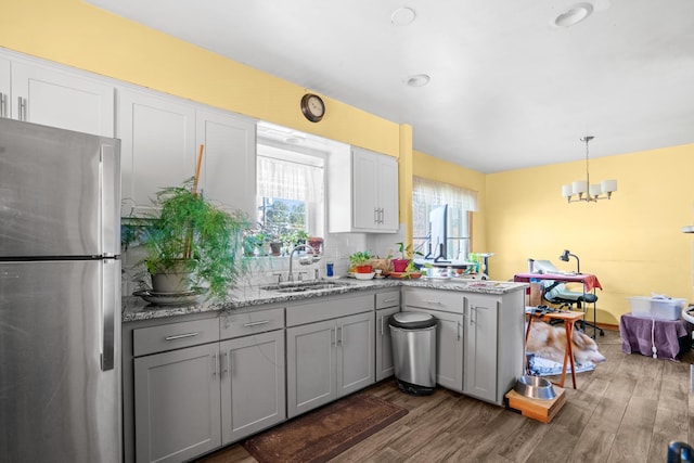 8014 W Summerdale Ave, Chicago, IL 60656 - kitchen with freestanding refrigerator, a sink, gray cabinets, dark wood finished floors, and a peninsula