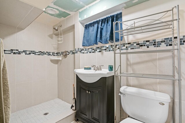 8014 W Summerdale Ave, Chicago, IL 60656 - bathroom featuring tile walls, a shower stall, toilet, and vanity