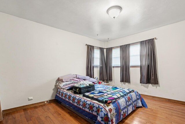8014 W Summerdale Ave, Chicago, IL 60656 - bedroom with baseboards and wood finished floors