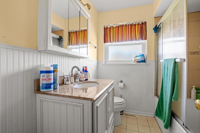 8014 W Summerdale Ave, Chicago, IL 60656 - full bath featuring wainscoting, vanity, tile patterned flooring, toilet, and enclosed tub / shower combo