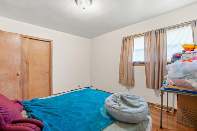 8014 W Summerdale Ave, Chicago, IL 60656 - bedroom featuring wood finished floors, a closet, and baseboards