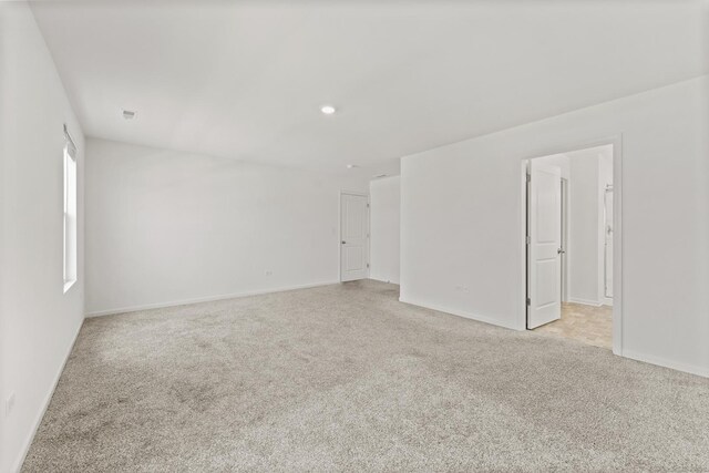 6712 Eich Dr, Joliet, IL 60431 - unfurnished room featuring light carpet, baseboards, and recessed lighting