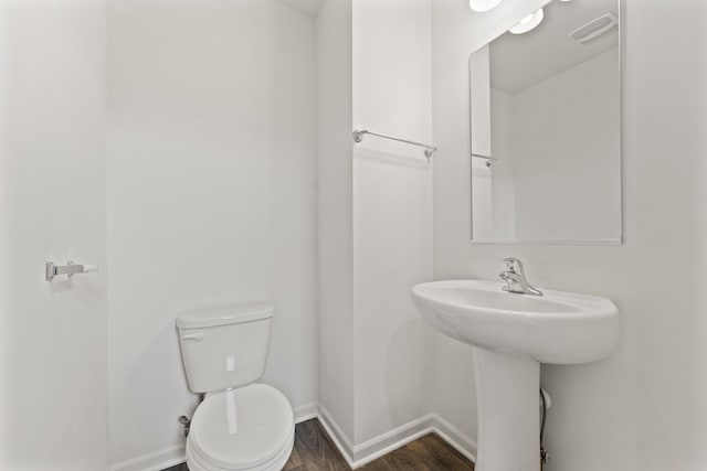 6712 Eich Dr, Joliet, IL 60431 - bathroom featuring baseboards, wood finished floors, toilet, and a sink