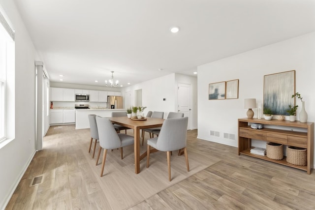 6712 Eich Dr, Joliet, IL 60431 - dining space featuring a chandelier, light wood-style flooring, recessed lighting, and baseboards