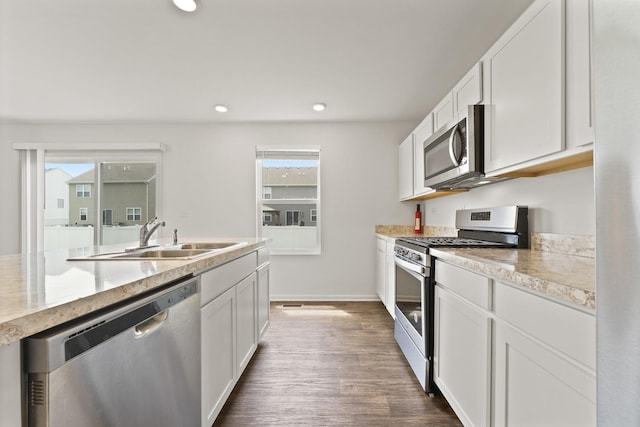 6712 Eich Dr, Joliet, IL 60431 - kitchen with stainless steel appliances, a sink, dark wood-style flooring, white cabinets, and recessed lighting