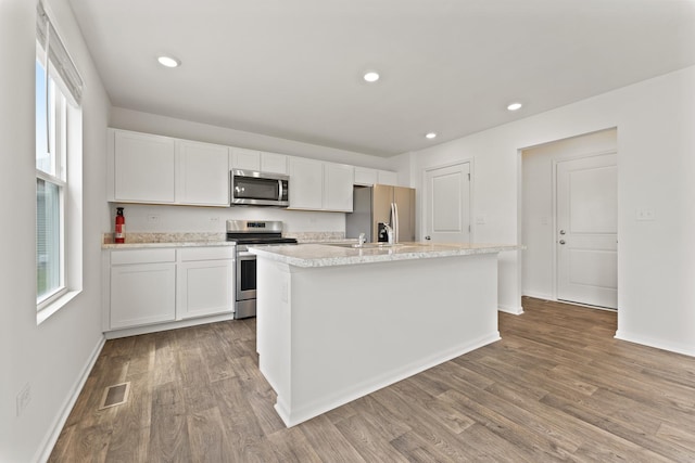 6712 Eich Dr, Joliet, IL 60431 - kitchen with stainless steel appliances, wood finished floors, light countertops, white cabinets, and recessed lighting