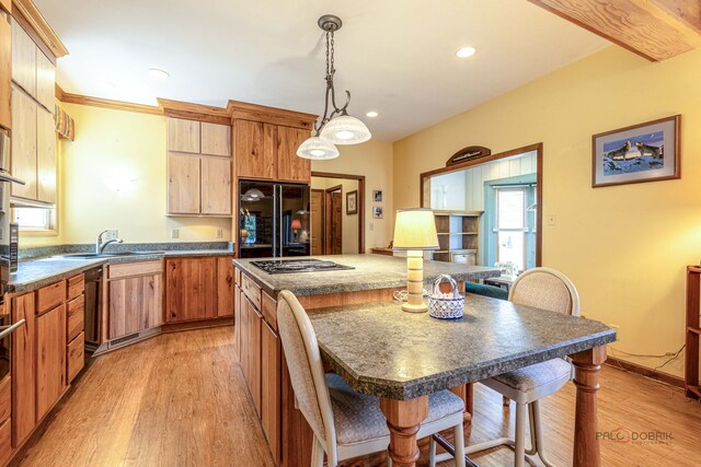 3206 Turnberry Dr, Mchenry, IL 60050 - kitchen featuring black refrigerator, light wood finished floors, dark countertops, a center island, and stainless steel gas cooktop
