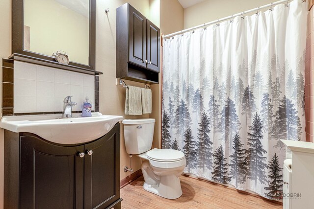 3206 Turnberry Dr, Mchenry, IL 60050 - bathroom with toilet, wood finished floors, vanity, a shower with curtain, and tasteful backsplash