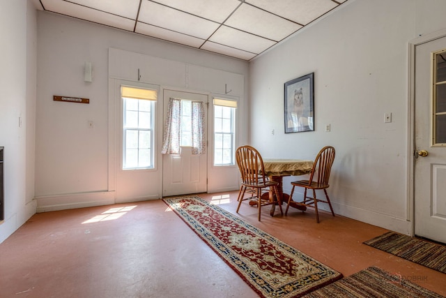 3206 Turnberry Dr, Mchenry, IL 60050 - dining room featuring concrete flooring, a paneled ceiling, and baseboards