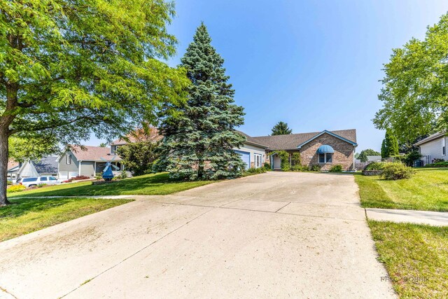 3206 Turnberry Dr, Mchenry, IL 60050 - view of front of house with concrete driveway, a front yard, and an attached garage