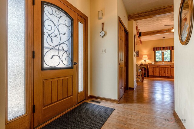 3206 Turnberry Dr, Mchenry, IL 60050 - entrance foyer featuring beam ceiling, light wood finished floors, and baseboards