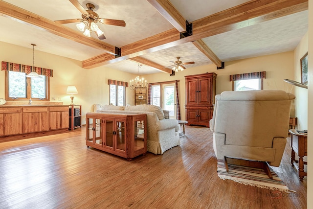 3206 Turnberry Dr, Mchenry, IL 60050 - living room with a ceiling fan, light wood-style flooring, beamed ceiling, plenty of natural light, and a chandelier