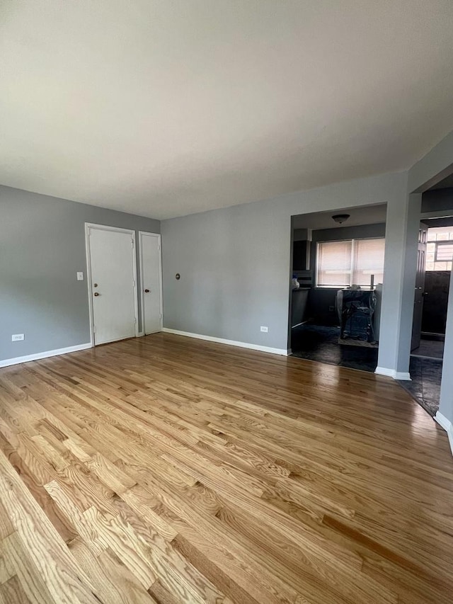 1100 Hannah Ave Unit 104, Forest Park, IL 60130 - unfurnished living room featuring wood finished floors and baseboards