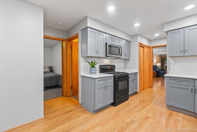 9544 S Avers Ave, Evergreen Park, IL 60805 - kitchen with gas stove, stainless steel microwave, gray cabinetry, light countertops, and recessed lighting
