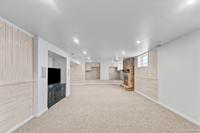 9544 S Avers Ave, Evergreen Park, IL 60805 - unfurnished living room featuring carpet, a stone fireplace, wooden walls, recessed lighting, and baseboards