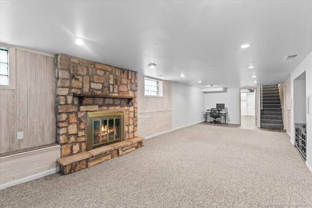 9544 S Avers Ave, Evergreen Park, IL 60805 - unfurnished living room featuring a stone fireplace, wooden walls, carpet, stairway, and baseboards