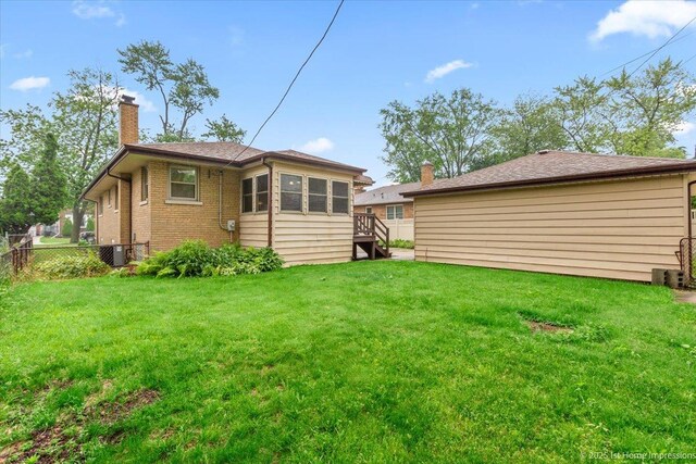 9544 S Avers Ave, Evergreen Park, IL 60805 - back of property with a chimney, brick siding, central AC unit, and stairs