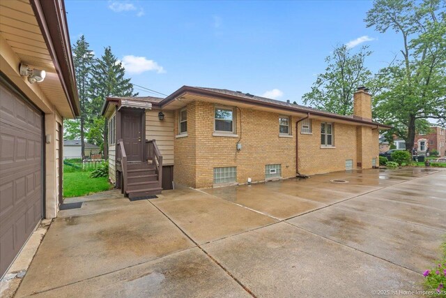 9544 S Avers Ave, Evergreen Park, IL 60805 - view of side of property with a chimney, brick siding, and roof with shingles