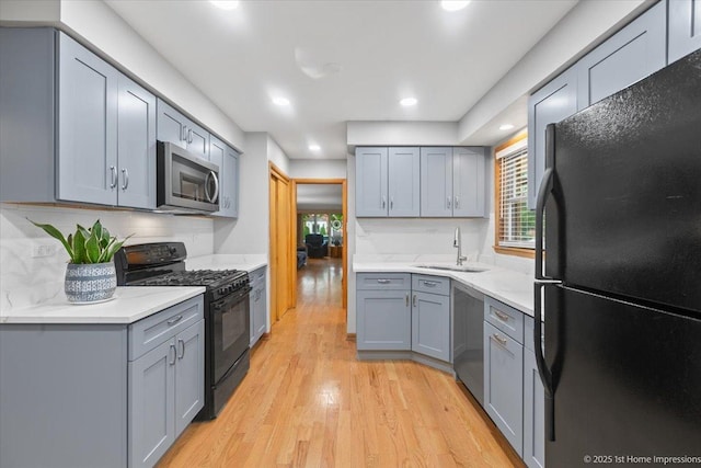 9544 S Avers Ave, Evergreen Park, IL 60805 - kitchen featuring black appliances, a sink, gray cabinets, light wood-style floors, and recessed lighting