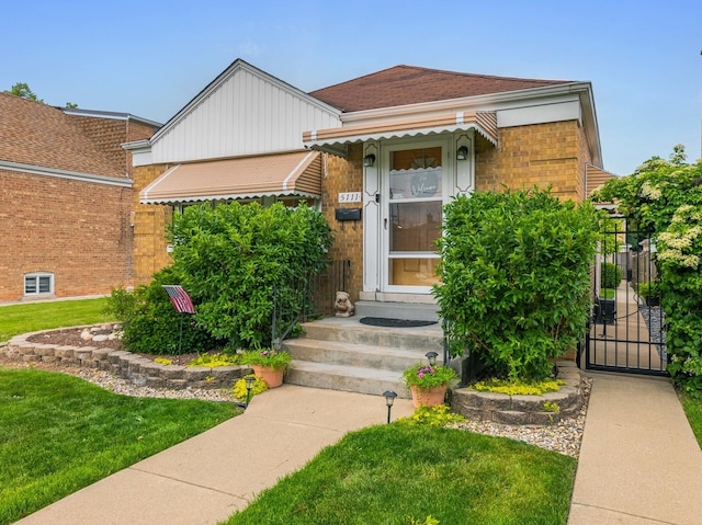5111 S Luna Ave, Chicago, IL 60638 - view of front of house with a gate, a front yard, entry steps, and brick siding