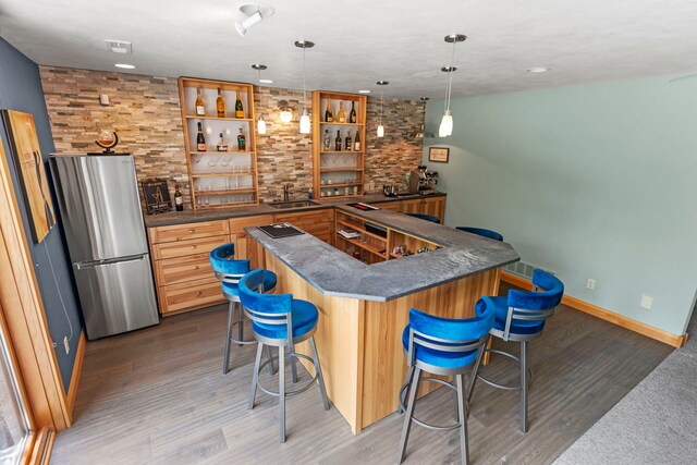 515 Stone Ridge Ln, Cherry Valley, IL 61016 - indoor wet bar with freestanding refrigerator, light wood-style floors, decorative light fixtures, recessed lighting, and electric cooktop