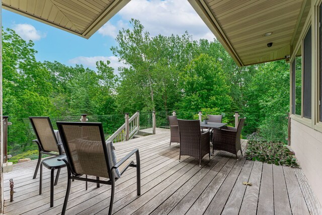 515 Stone Ridge Ln, Cherry Valley, IL 61016 - wooden terrace featuring outdoor dining space and view of scattered trees