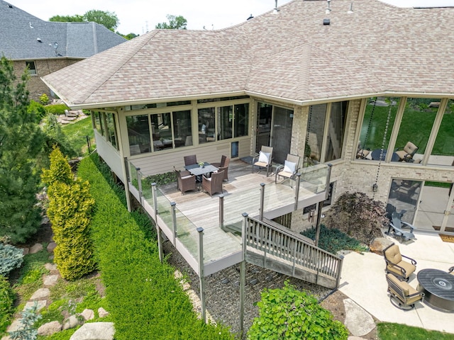 515 Stone Ridge Ln, Cherry Valley, IL 61016 - rear view of house with a deck, roof with shingles, and a sunroom
