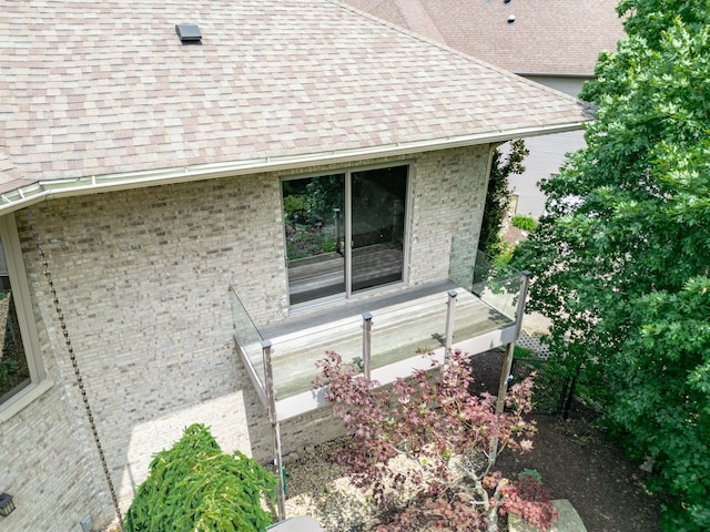 515 Stone Ridge Ln, Cherry Valley, IL 61016 - view of side of property with a shingled roof and brick siding
