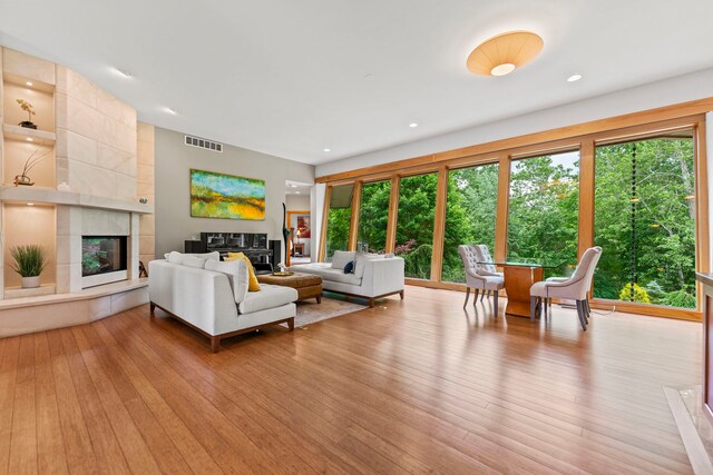 515 Stone Ridge Ln, Cherry Valley, IL 61016 - living room featuring a tiled fireplace and light wood finished floors