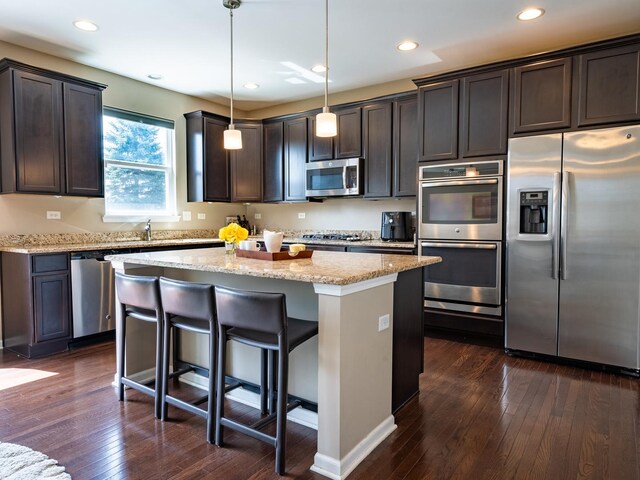 3740 Ryder Ct, Naperville, IL 60564 - kitchen with stainless steel appliances, a kitchen island, dark brown cabinets, dark wood-style flooring, and recessed lighting