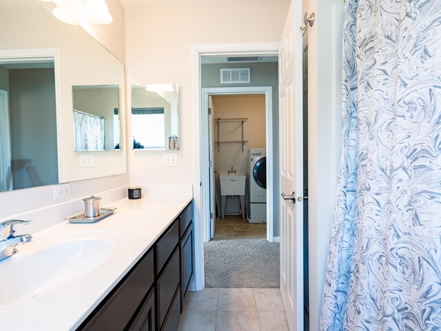 3740 Ryder Ct, Naperville, IL 60564 - bathroom with vanity, washer / dryer, tile patterned floors, and curtained shower