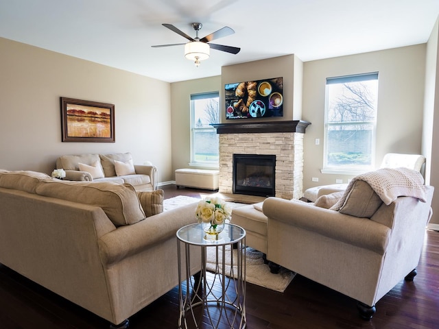 3740 Ryder Ct, Naperville, IL 60564 - living room featuring dark wood finished floors, a ceiling fan, a stone fireplace, and baseboards