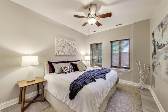 4950 N Western Ave Unit 101, Chicago, IL 60625 - bedroom with baseboards, light wood-style floors, and ceiling fan