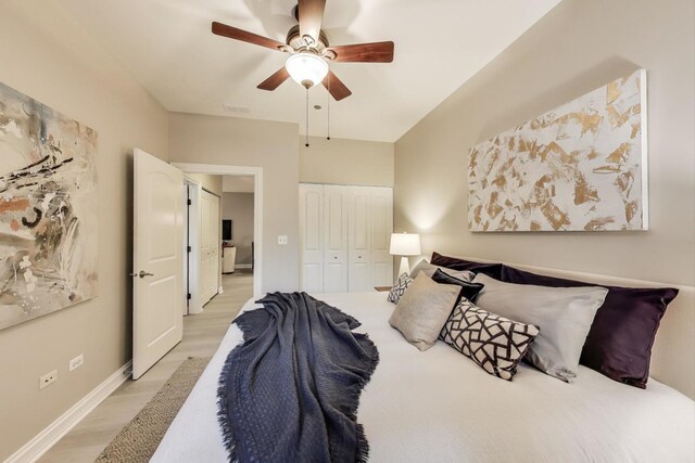 4950 N Western Ave Unit 101, Chicago, IL 60625 - bedroom featuring light wood-style floors, a closet, ceiling fan, and baseboards