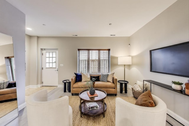 4950 N Western Ave Unit 101, Chicago, IL 60625 - living area with a baseboard heating unit, baseboards, light wood-type flooring, and recessed lighting