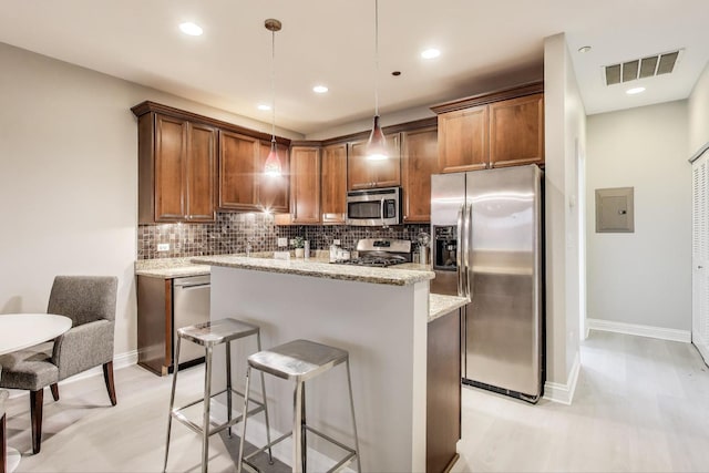 4950 N Western Ave Unit 101, Chicago, IL 60625 - kitchen with appliances with stainless steel finishes, tasteful backsplash, a kitchen island, a breakfast bar area, and recessed lighting