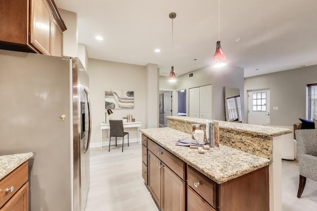 4950 N Western Ave Unit 101, Chicago, IL 60625 - kitchen featuring stainless steel refrigerator with ice dispenser, a center island, open floor plan, hanging light fixtures, and light stone countertops