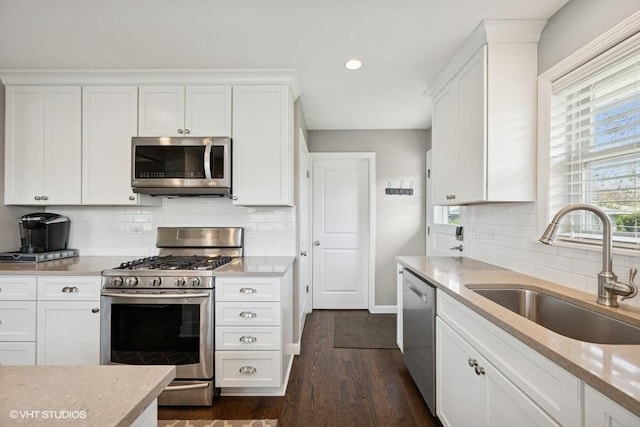 907 N Wilshire Ln, Arlington Heights, IL 60004 - kitchen with stainless steel appliances, a sink, white cabinetry, decorative backsplash, and recessed lighting