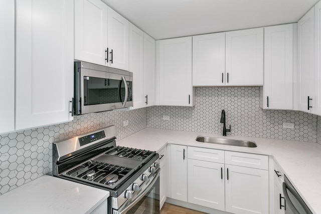 18200 Fountainbleau Dr, Hazel Crest, IL 60429 - kitchen featuring appliances with stainless steel finishes, a sink, backsplash, and white cabinetry