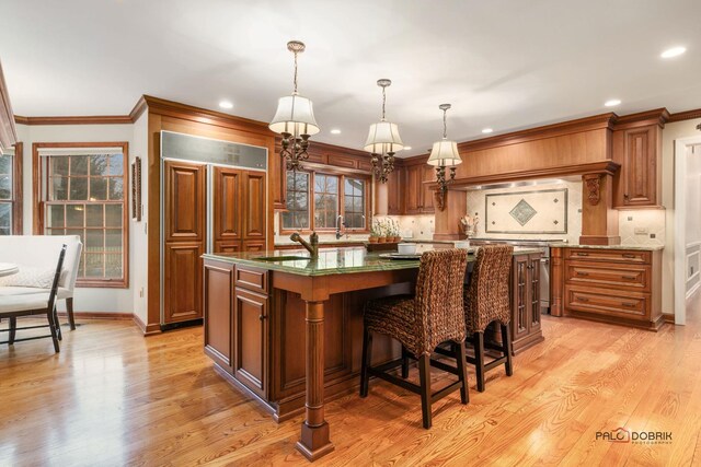 36955 N Fox Hill Dr, Wadsworth, IL 60083 - kitchen featuring paneled built in fridge, a kitchen island, recessed lighting, backsplash, and light wood-style floors