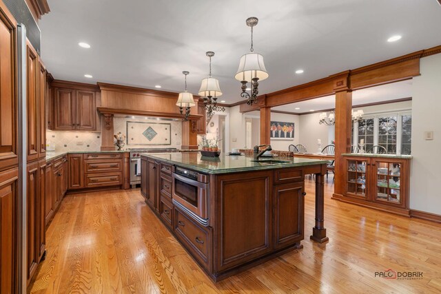 36955 N Fox Hill Dr, Wadsworth, IL 60083 - kitchen with a chandelier, appliances with stainless steel finishes, light wood-style flooring, tasteful backsplash, and recessed lighting