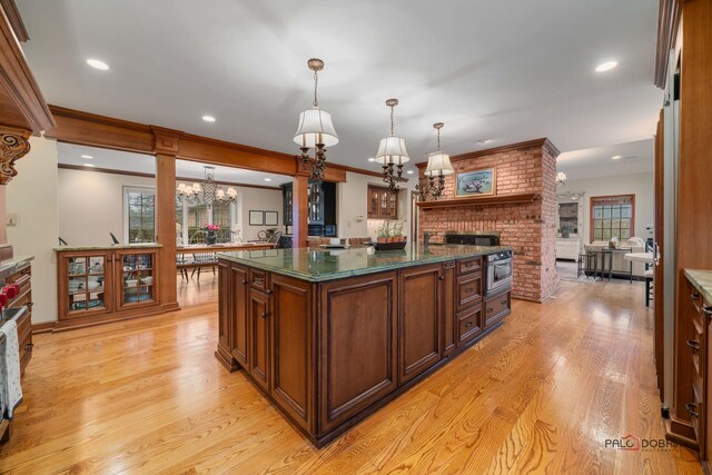36955 N Fox Hill Dr, Wadsworth, IL 60083 - kitchen featuring a chandelier, dark countertops, light wood-style floors, recessed lighting, and a brick fireplace