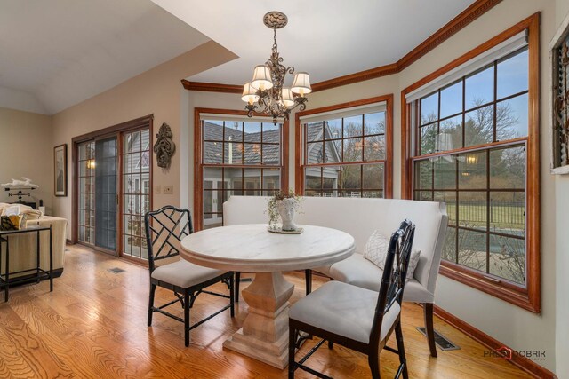 36955 N Fox Hill Dr, Wadsworth, IL 60083 - dining space featuring a chandelier, light wood-style floors, and crown molding