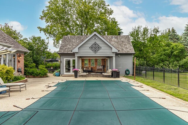 36955 N Fox Hill Dr, Wadsworth, IL 60083 - view of pool featuring an exterior structure, an outbuilding, a patio area, outdoor lounge area, and french doors