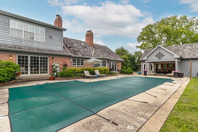 36955 N Fox Hill Dr, Wadsworth, IL 60083 - view of swimming pool featuring a patio area, a covered pool, a storage structure, and an outbuilding