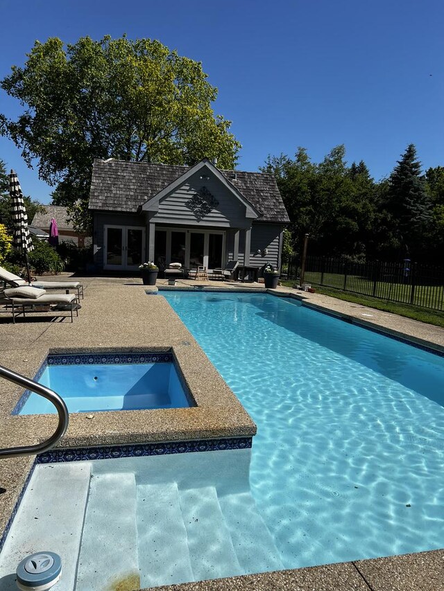 36955 N Fox Hill Dr, Wadsworth, IL 60083 - view of pool with an in-ground hot tub, a storage structure, an outbuilding, a patio, and french doors